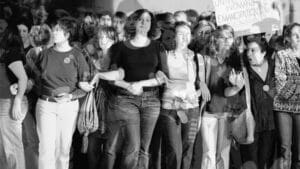 Black and white image of women with arms interlaced